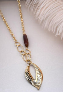 Long gold with a leaf effect design necklace